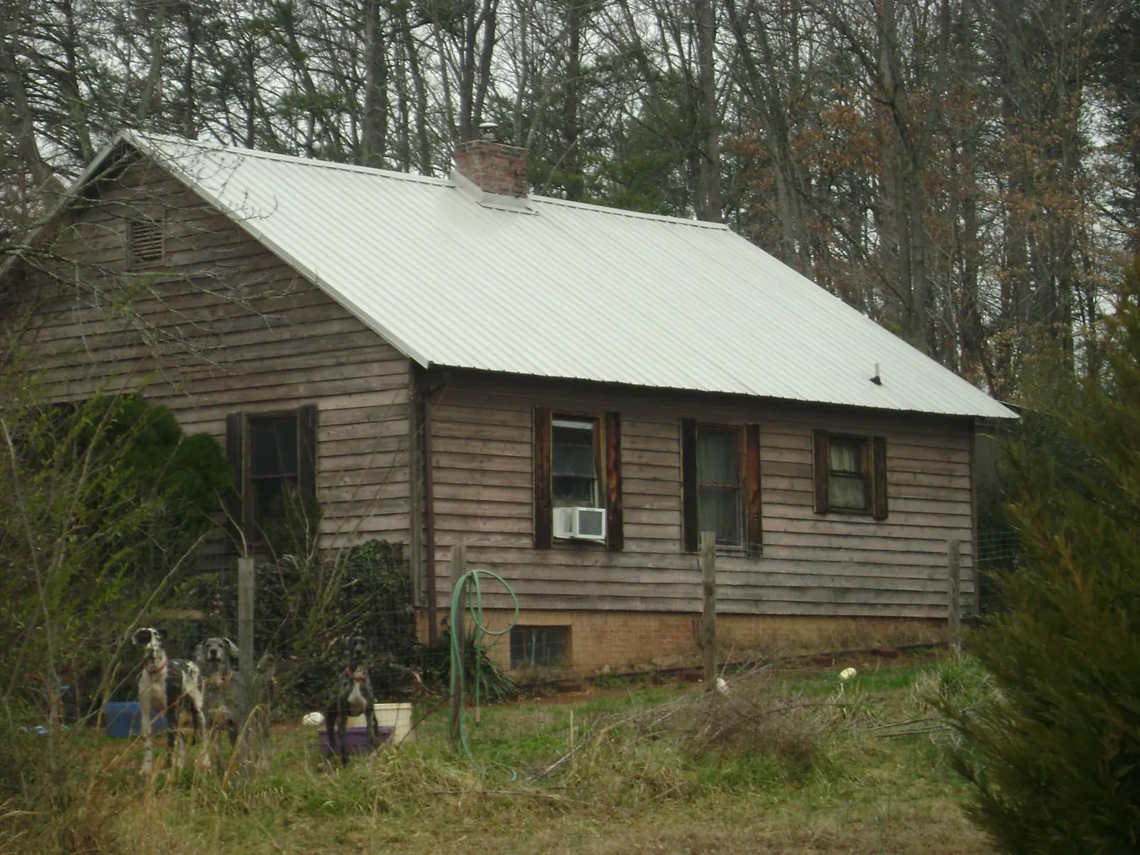 White metal roof on an old wood sided farmhouse, from a Metal Roof Installation job in Rudd